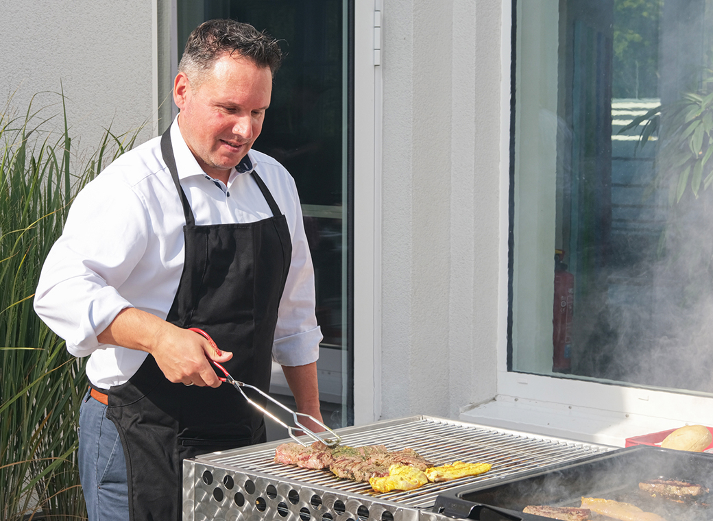 Daniel Sugg, managing partner, grills for the employees.